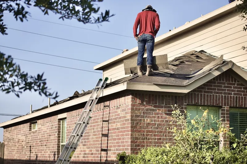 Professional roofer working on a residential roof in Austin's Estates